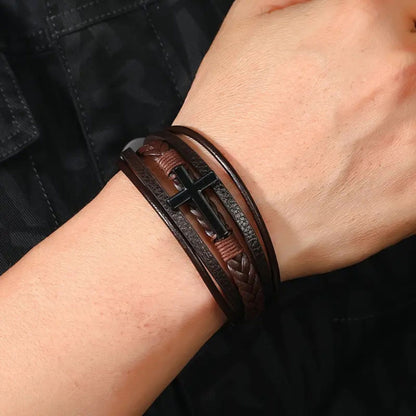 Adjustable braided faux leather men’s bracelet with polished cross charm.